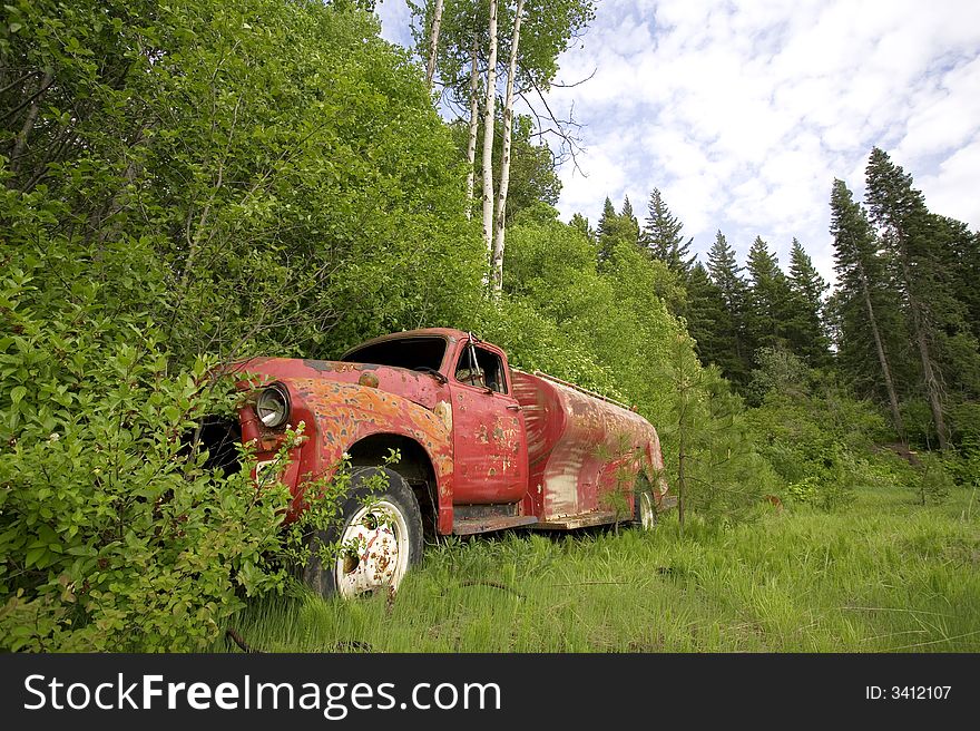Abandoned old truck by the forest