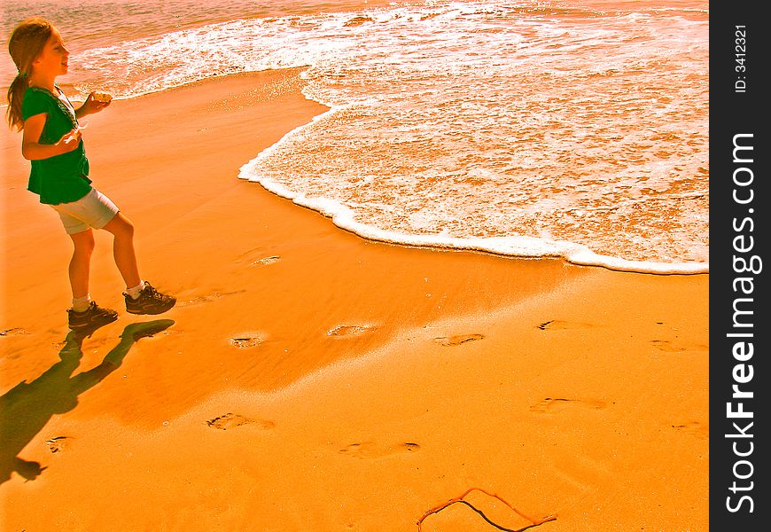 Teasing the waves, running, watching footprints disappear. Teasing the waves, running, watching footprints disappear