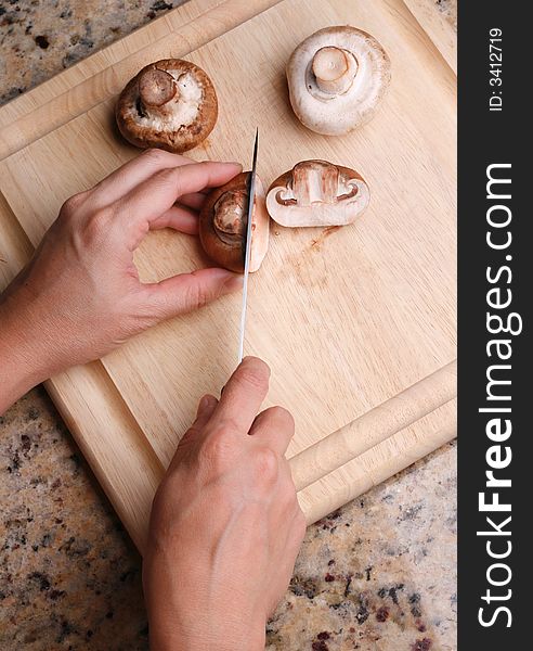 Wooden cutting board slicing mashrooms. Wooden cutting board slicing mashrooms.