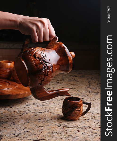 Pouring wooden tea cup or coffee cup. Pouring wooden tea cup or coffee cup