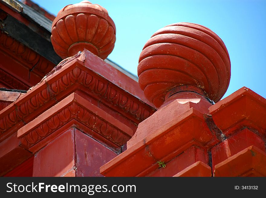 Ornamental clay red orbs atop an old downtown bank building