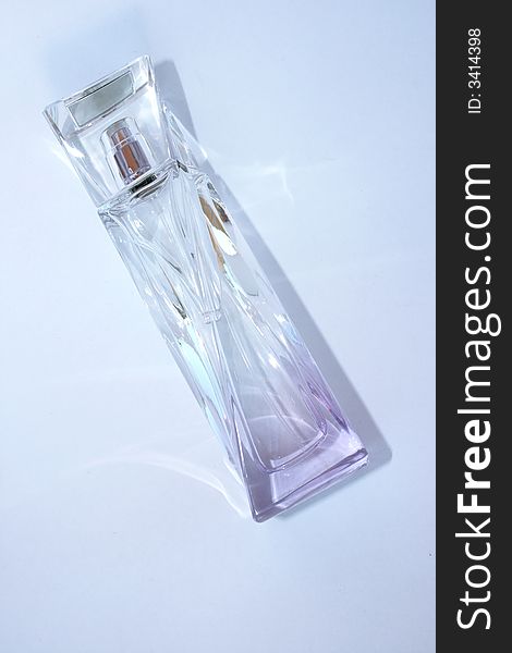 Bottle of perfume isolated on blue background.