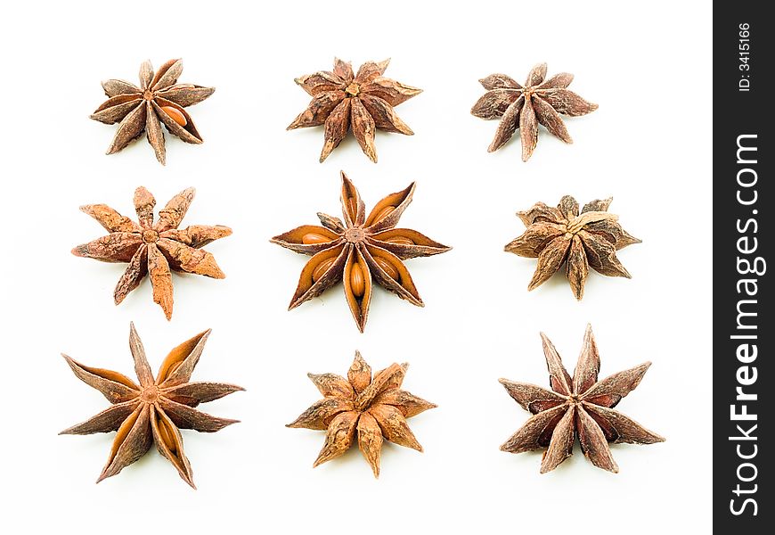 Arrangement of nine star anise in three rows alternating between top and bottom view. Arrangement of nine star anise in three rows alternating between top and bottom view.