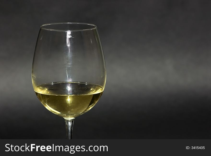 Detail of a white Italian wine glass on black background. Great aperitif. Detail of a white Italian wine glass on black background. Great aperitif