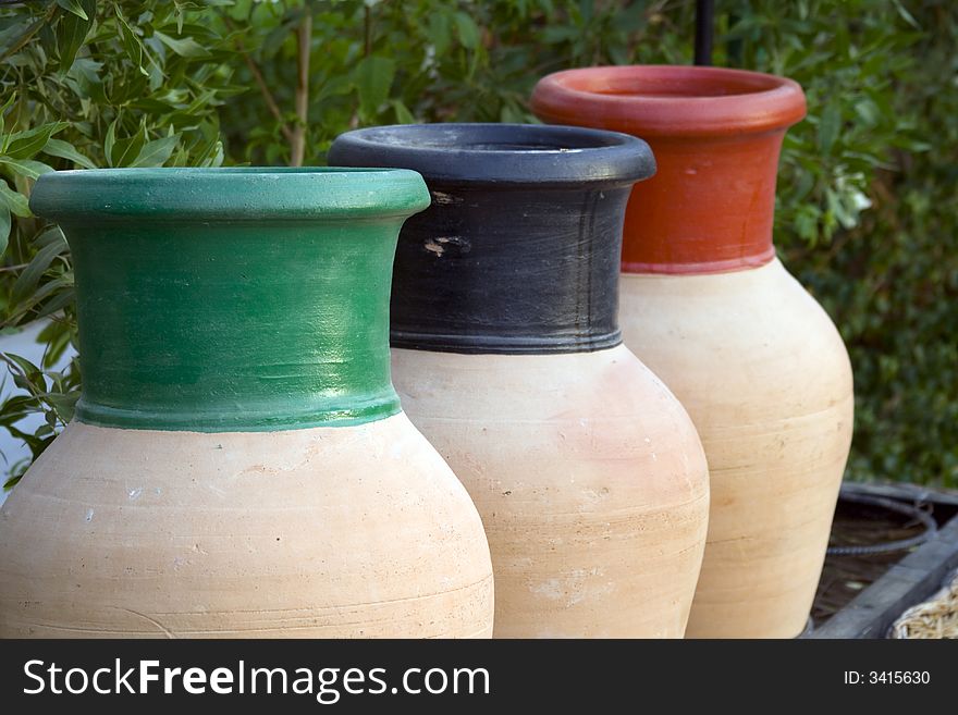 Three pots with different colors to be used for recycling of different types of garbage. Selective focus on the green pot. Three pots with different colors to be used for recycling of different types of garbage. Selective focus on the green pot...