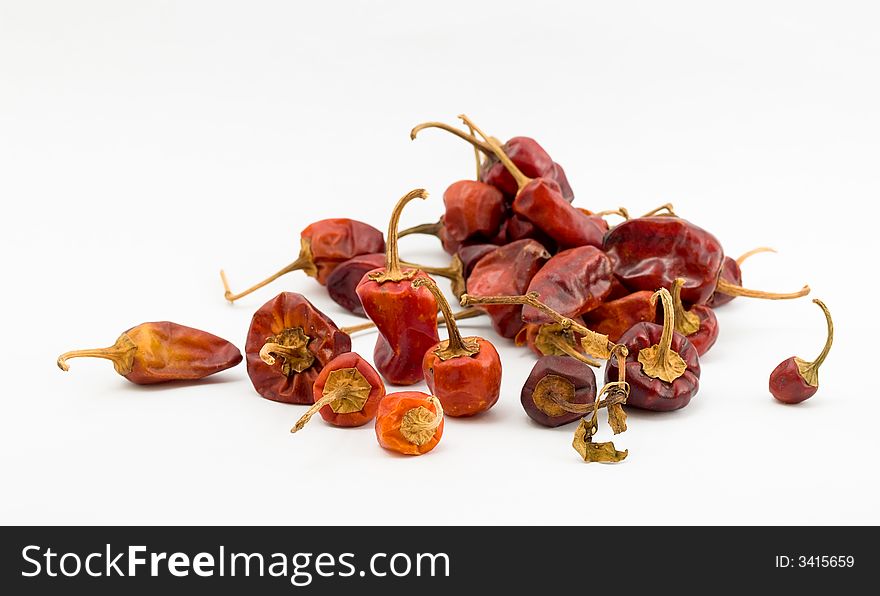 Still life of a handful of Habanero chilies of various sizes, shapes, colors, and orientation, on white background. Still life of a handful of Habanero chilies of various sizes, shapes, colors, and orientation, on white background.