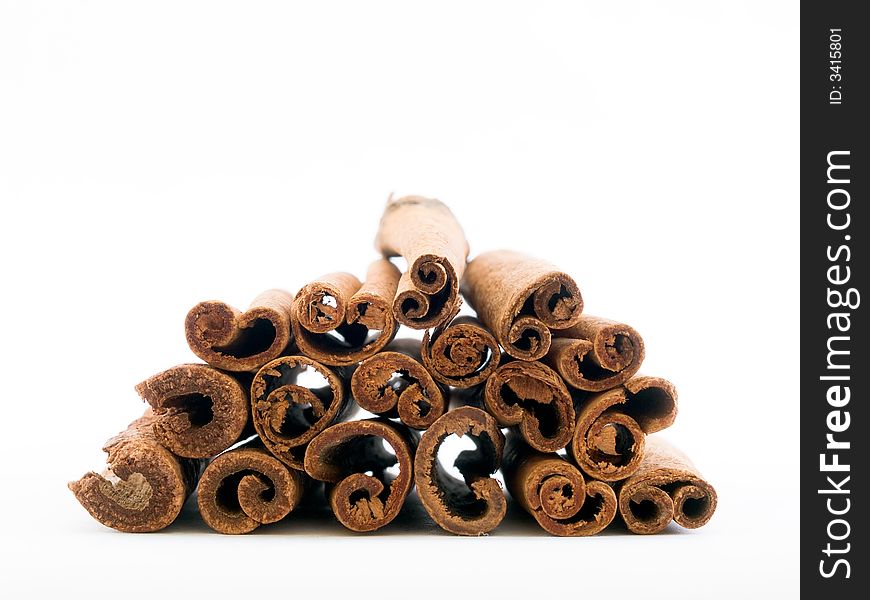 End-wise perspective of a pile of cinnamon sticks isolated on white background. End-wise perspective of a pile of cinnamon sticks isolated on white background.