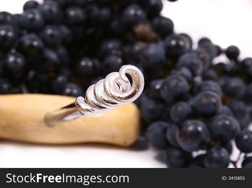 Closeup of bunch of black juicy grapes with drop of water over white