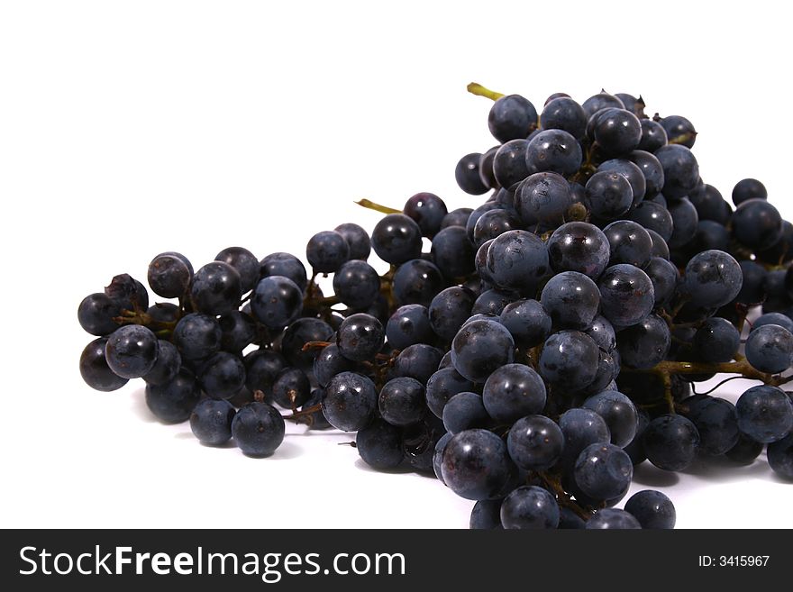 Closeup of bunch of black juicy grapes with drop of water over white