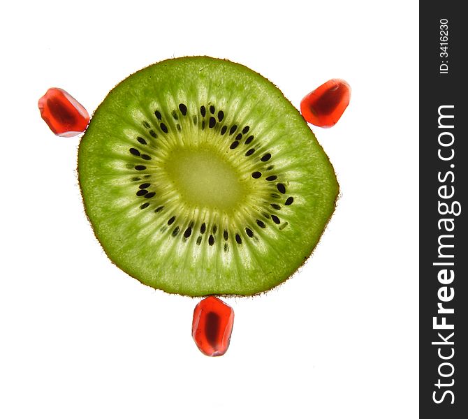 One kiwi and pomegranate on a white background