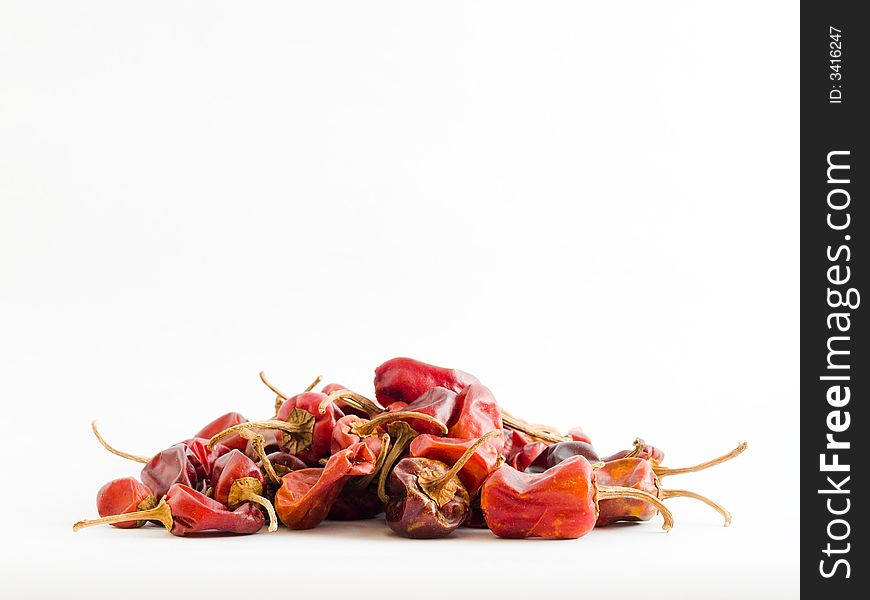 Still life of a heap of Habanero chilies haphazardly arranged on white background. Still life of a heap of Habanero chilies haphazardly arranged on white background.