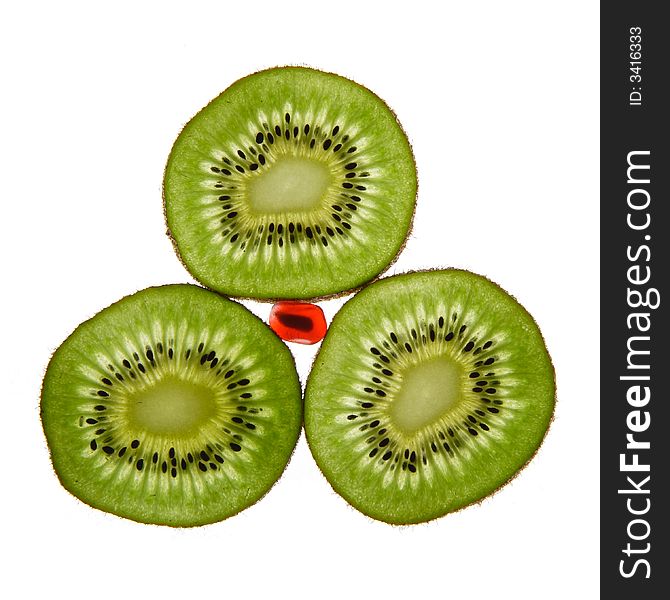 Three kiwis and pomegranate on a white background