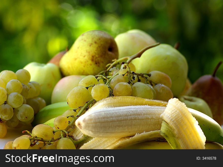 Yellow banana and green apple on green background. Yellow banana and green apple on green background