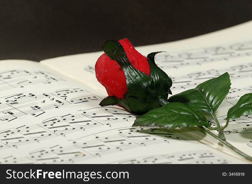 Photo of Sheetmusic With Red Fabric Rose - Sheetmusic Background