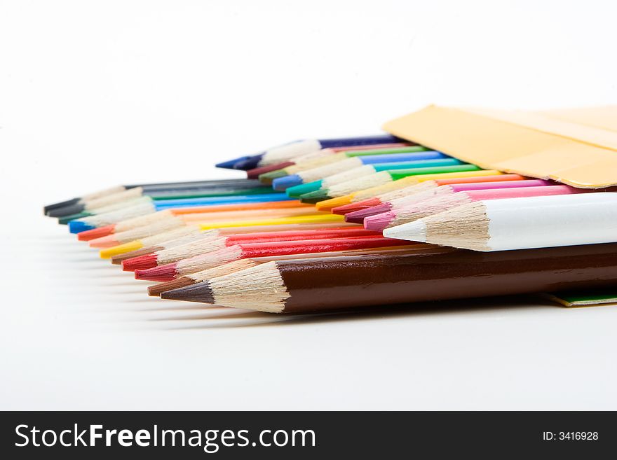 Colored wooden crayons/pencils in a box. Colored wooden crayons/pencils in a box.