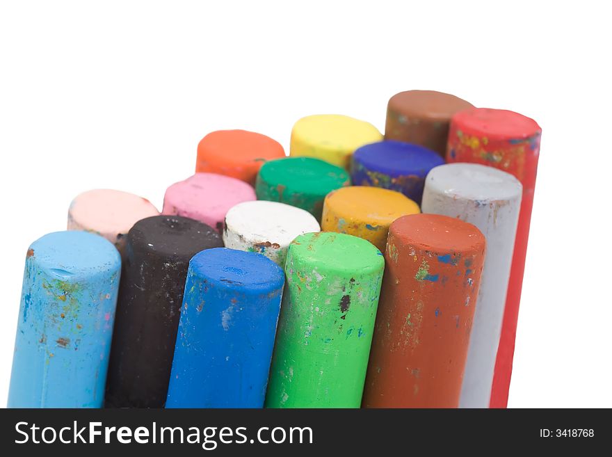 Stacked together isolated pastel crayons
