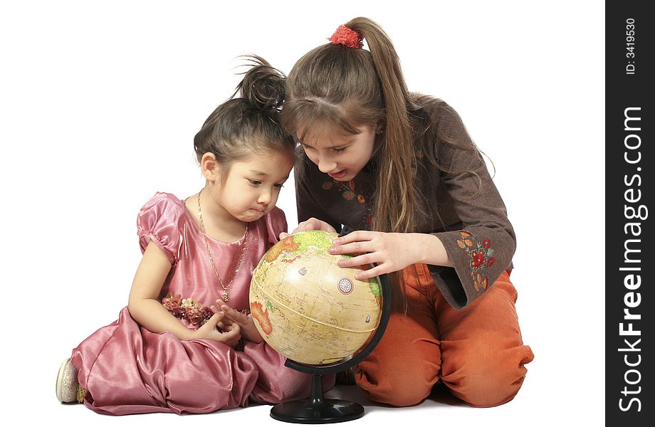 Two girls consider globe