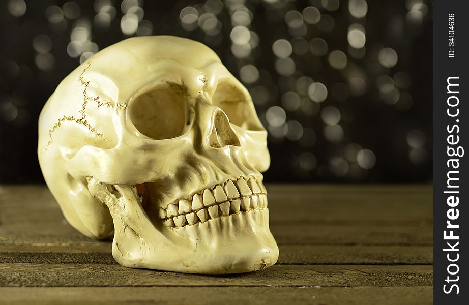 Human skull on glitter background