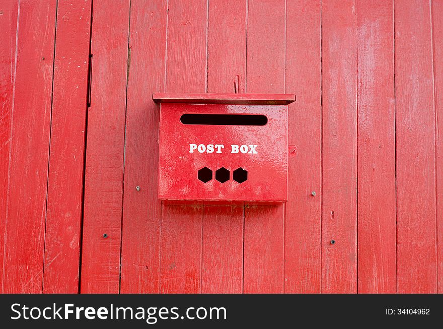 Red post box on wall