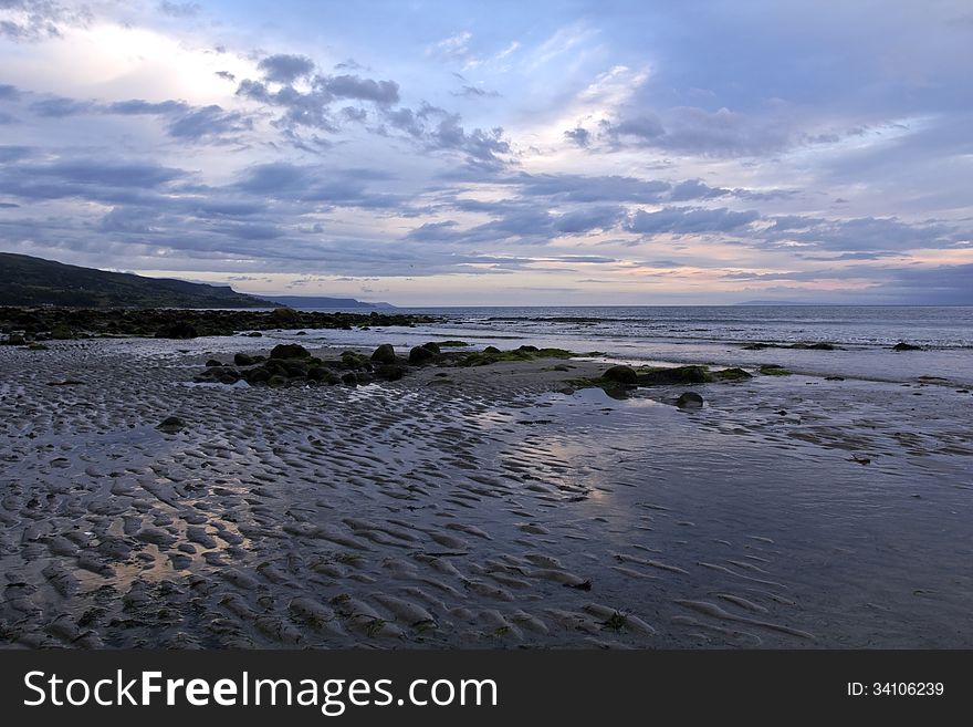 Early Morning Rocky Beach, Ballygally, Antrim Coast, Northern Ireland. Ballygally and Ballygally Castle with its ghost, are a popular destination along the Antrim Coast. Early Morning Rocky Beach, Ballygally, Antrim Coast, Northern Ireland. Ballygally and Ballygally Castle with its ghost, are a popular destination along the Antrim Coast.