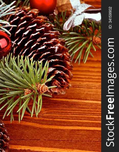 Arrangement of Spruce Branch, Fir Cones and Red Baubles closeup on Wooden background. Arrangement of Spruce Branch, Fir Cones and Red Baubles closeup on Wooden background