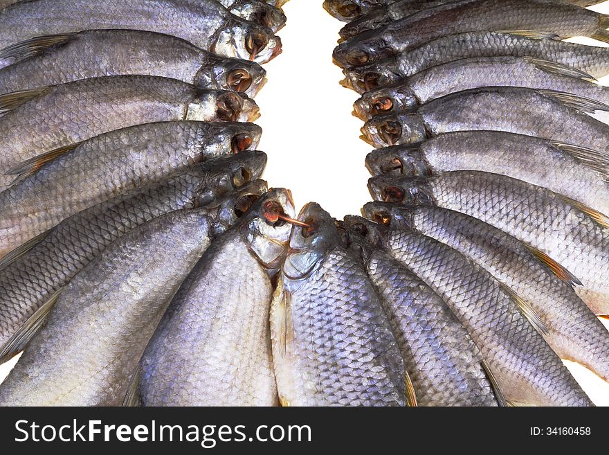 A lot of river fish salted and dried . Presented on a white background. A lot of river fish salted and dried . Presented on a white background.