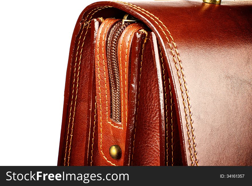 Details of Ginger Expensive Leather Briefcase with Zip and Gold Rivets closeup on white background. Details of Ginger Expensive Leather Briefcase with Zip and Gold Rivets closeup on white background