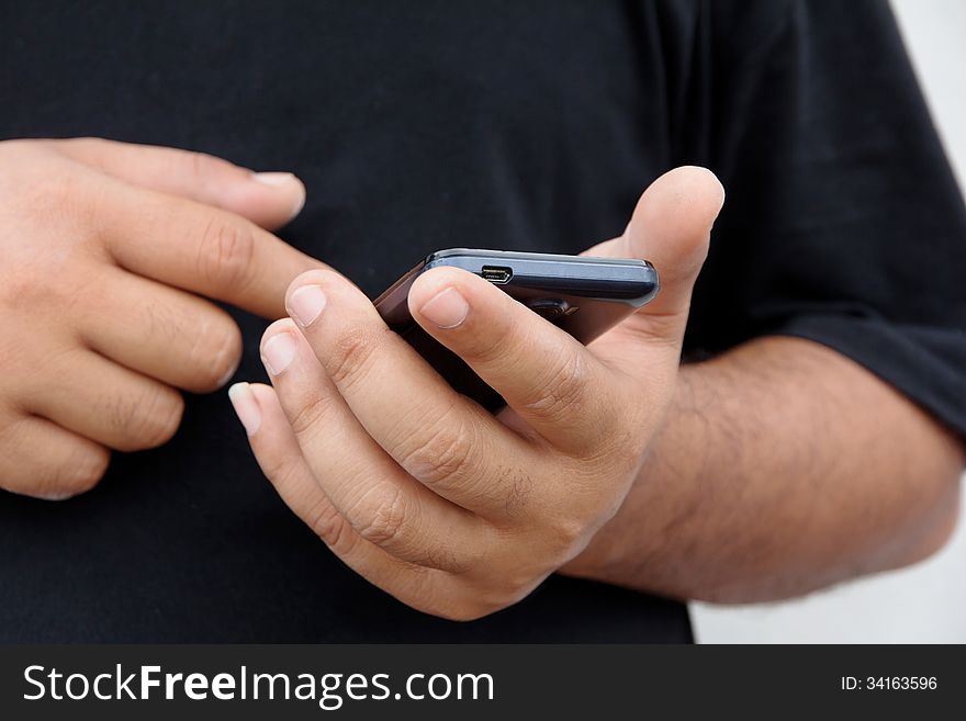 Image of fat man checking his phone