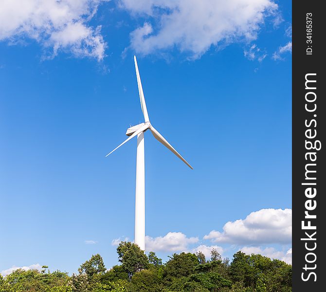 White electric wind mill with clear blue sky