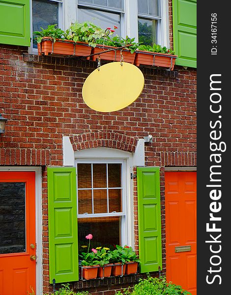 Colorful shop front with blank sign above window.