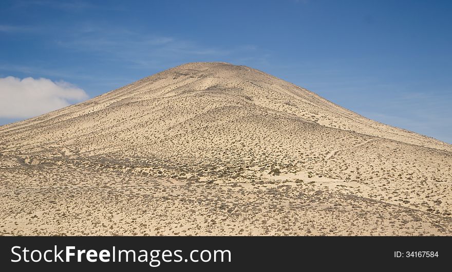 Sand And Rocky Mountains In Fuerteventura