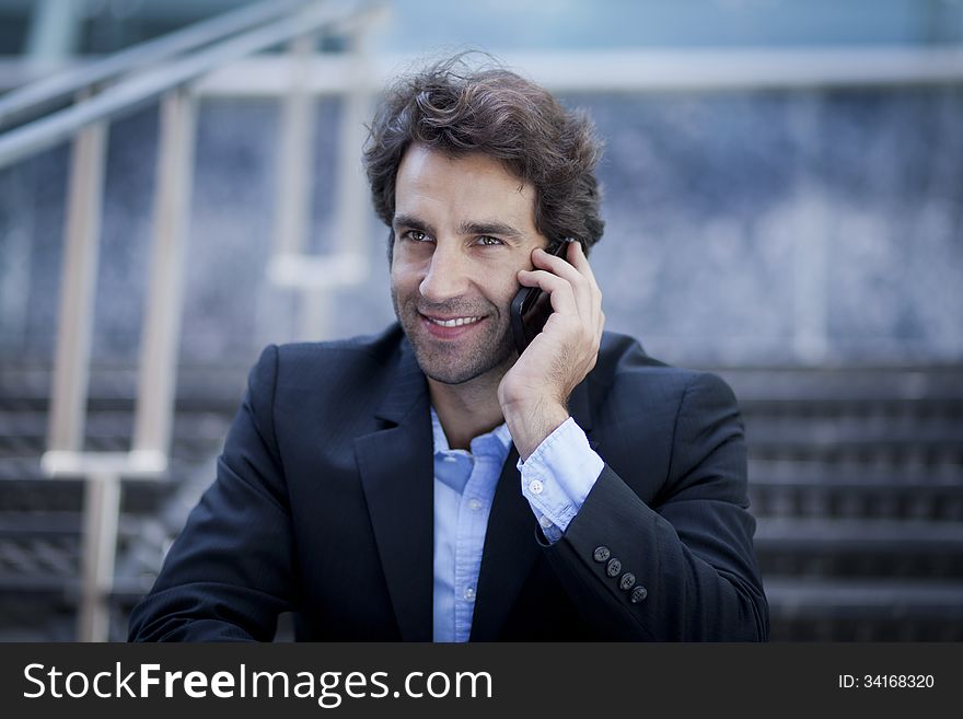 Successful Business man in front of his Office Smiling