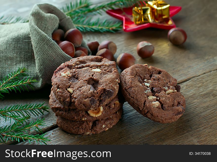 cookies and nutsand gift on the table with a fur-tree branch. cookies and nutsand gift on the table with a fur-tree branch