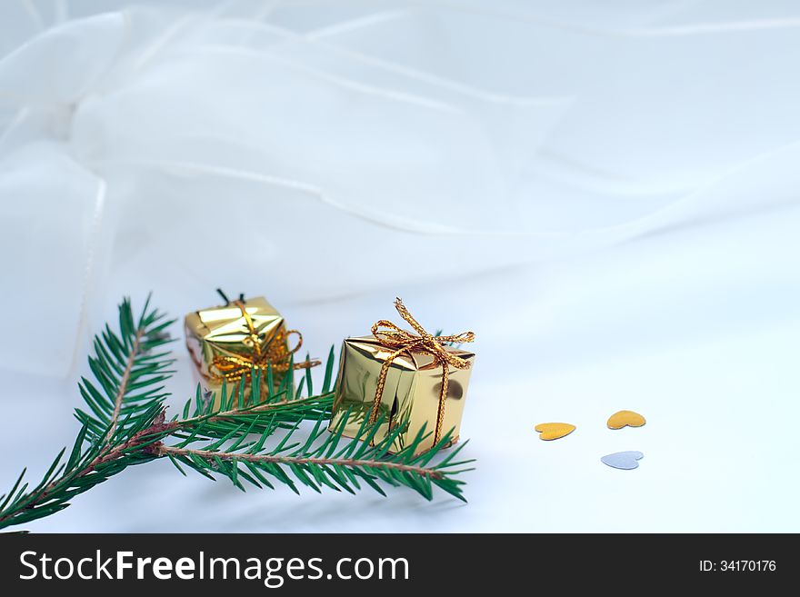 Fir branch and gift boxes on a light background