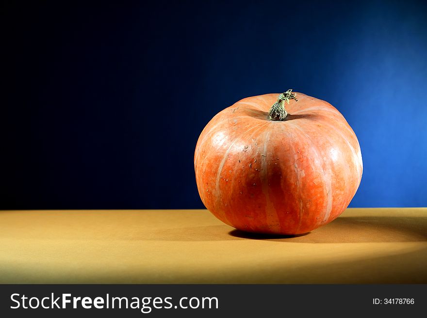 Ordinary orange pumpkin on nice dark background with free space for text. Ordinary orange pumpkin on nice dark background with free space for text