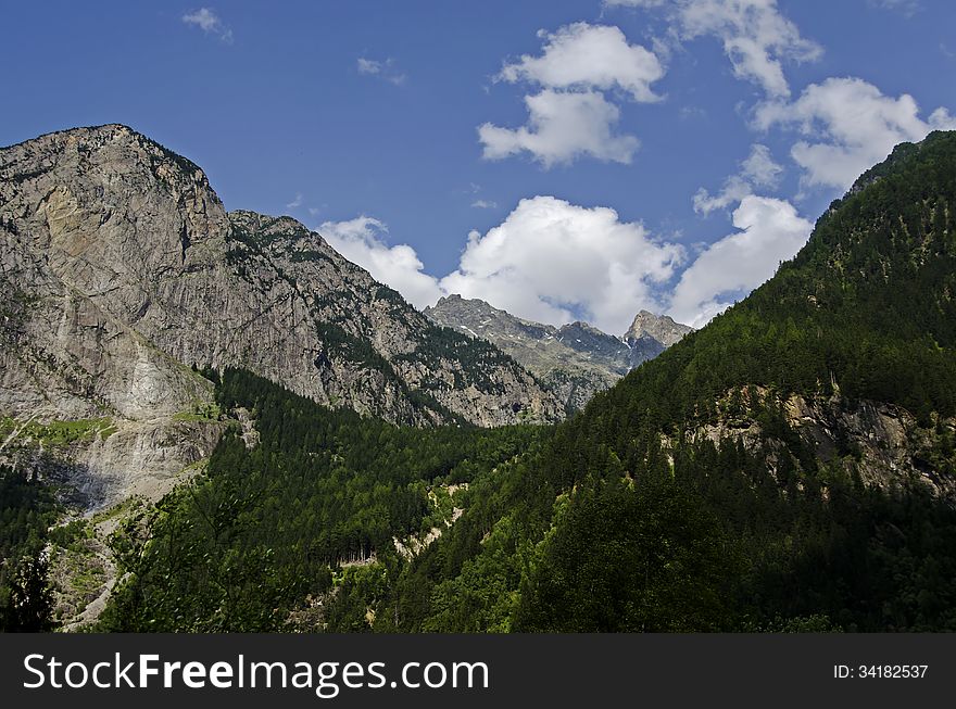Austrian landscape of the alps mountains with two peaks one with green forest and one naked