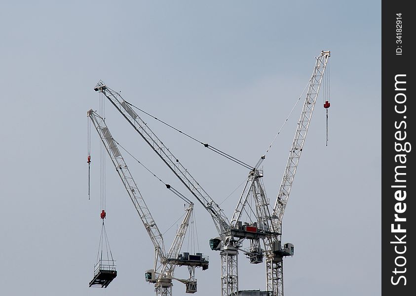 A Group of Tower Cranes on a Construction Site. A Group of Tower Cranes on a Construction Site.