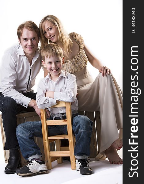 Young happy family portrait: mother, father and son. Isolated over white background. Young happy family portrait: mother, father and son. Isolated over white background.