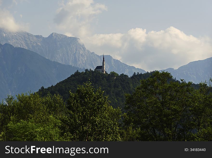 Church On The Top Of The Mountain On The Background Of The Alps