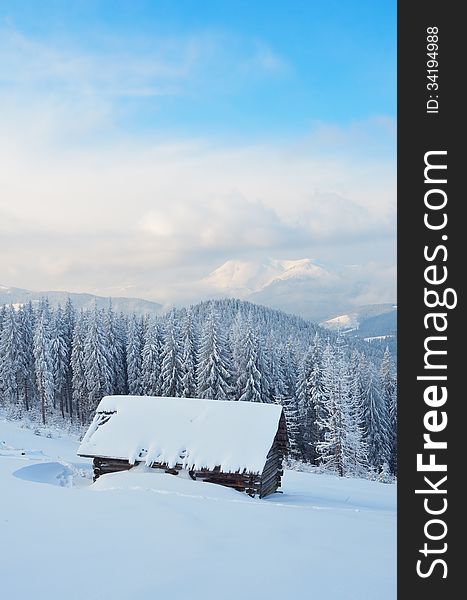 Winter mountain landscape with wooden hut and fresh snow. Carpathian mountains, Ukraine. Winter mountain landscape with wooden hut and fresh snow. Carpathian mountains, Ukraine