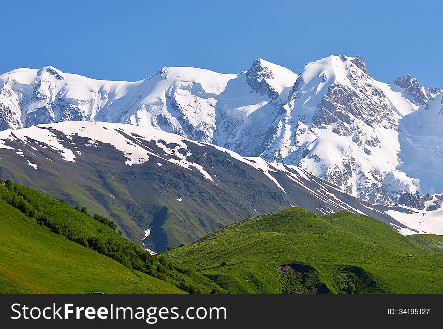 Mountain landscape with icy summit. Spur Shkhara, Georgia, Greater Caucasus Range. Mountain landscape with icy summit. Spur Shkhara, Georgia, Greater Caucasus Range