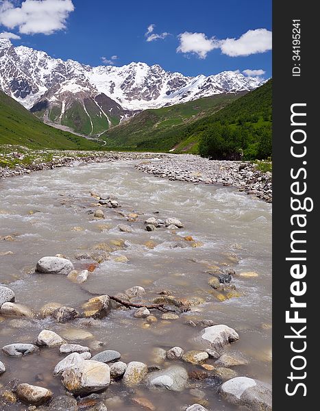 Mountain valley with a river. Shkhara Ridge Mountains, Georgia, Caucasus. Mountain valley with a river. Shkhara Ridge Mountains, Georgia, Caucasus