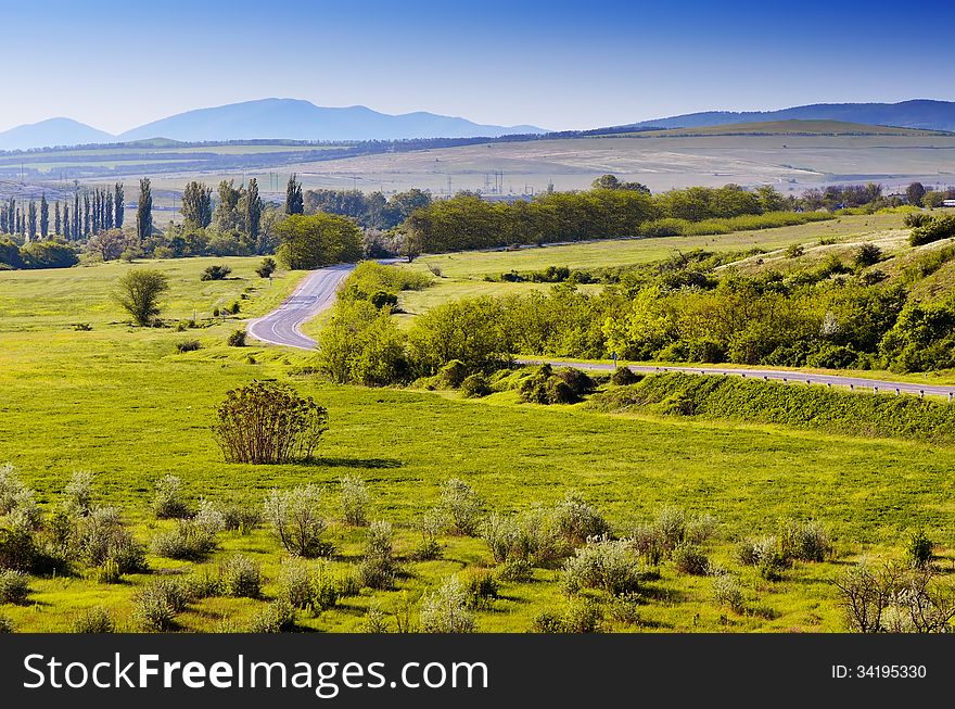 Morning landscape with a road in the valley of the sun in early spring. Crimea, Ukraine. Morning landscape with a road in the valley of the sun in early spring. Crimea, Ukraine