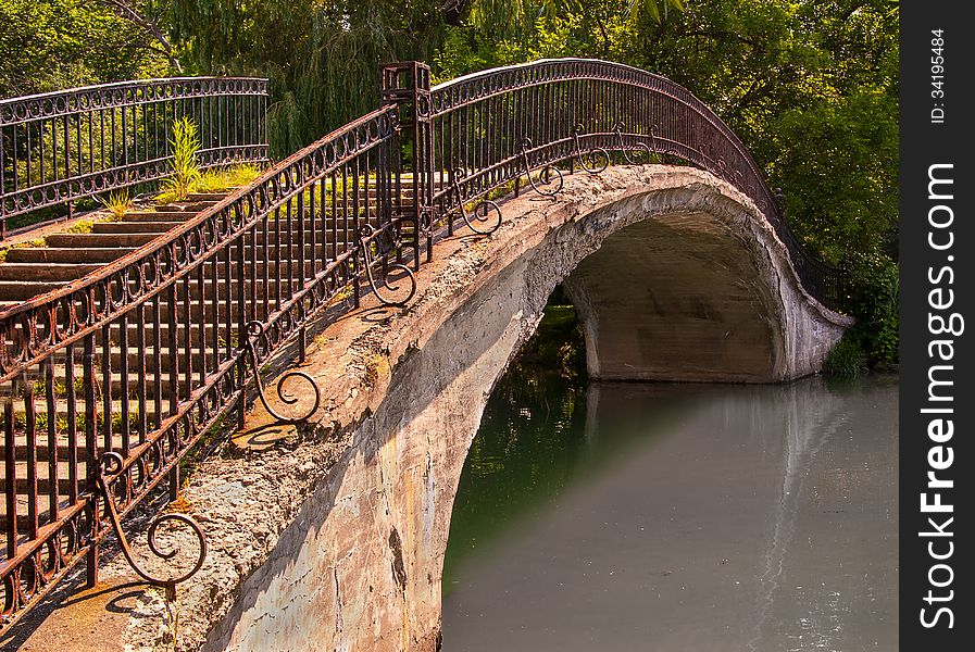 Old walk bridge with wrought iron railing. Old walk bridge with wrought iron railing