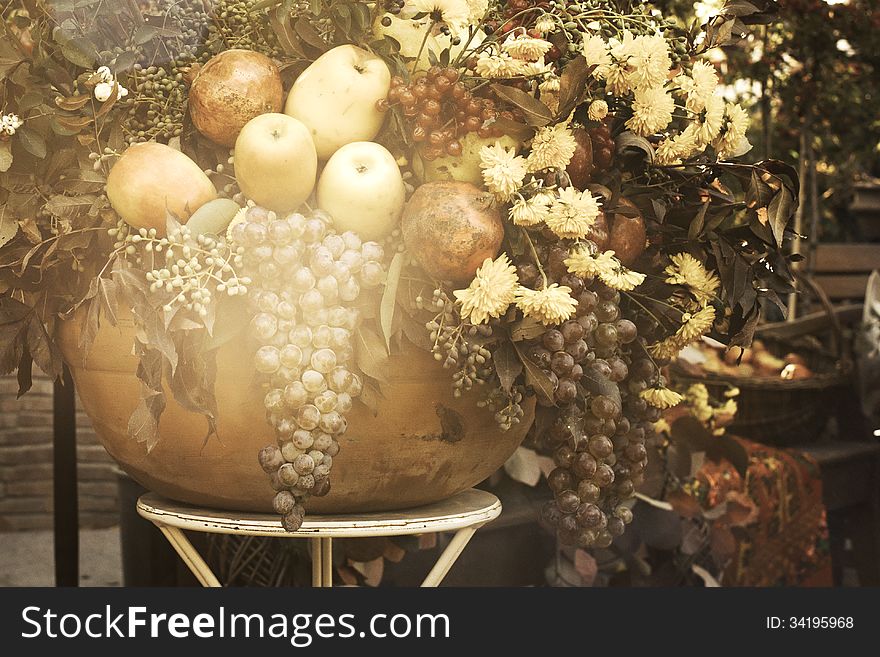 Bowl with autumn fruits and flowers in vintage style