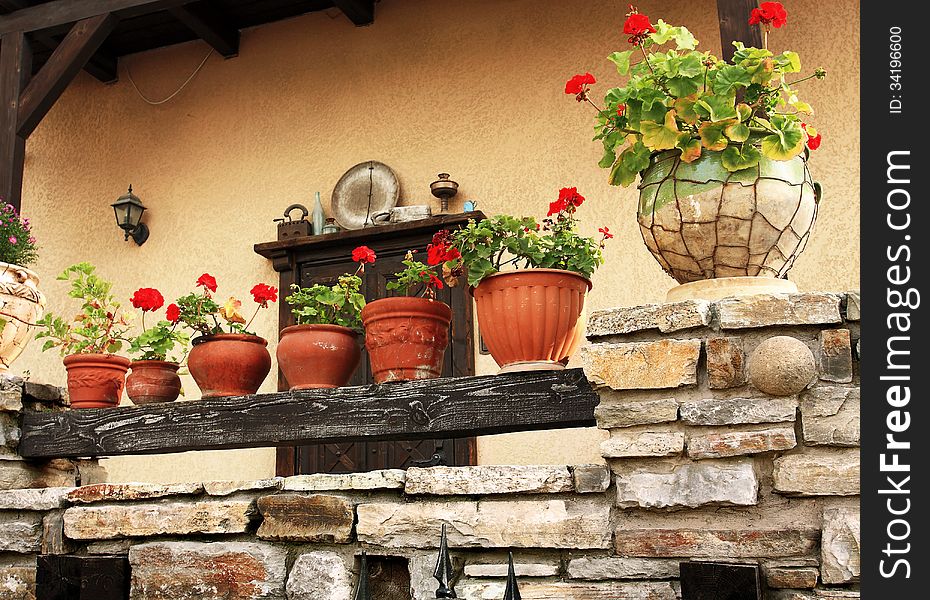 Flowers in a ceramic vase on the veranda of the rural house. Flowers in a ceramic vase on the veranda of the rural house