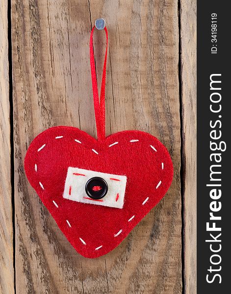 Heart decoration hanging against wooden background