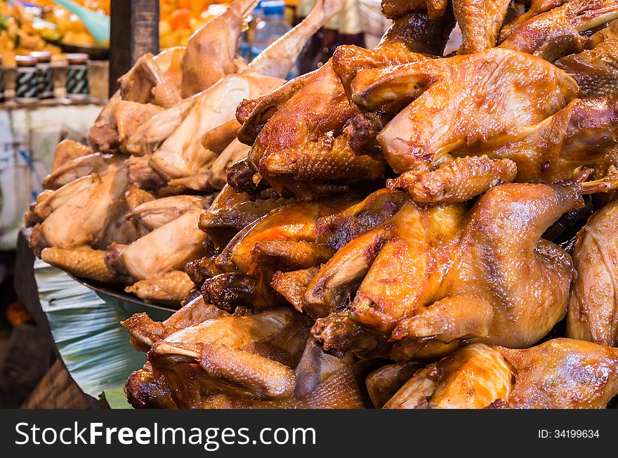 Stack of roasted and uncooked Chickens. Stack of roasted and uncooked Chickens