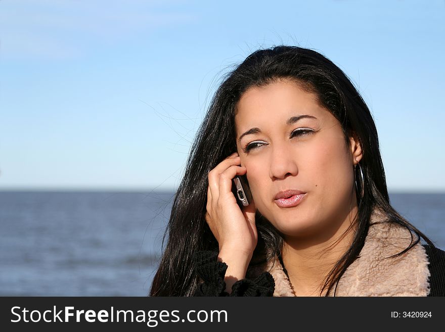 Digital photo of a woman talking with her phone.