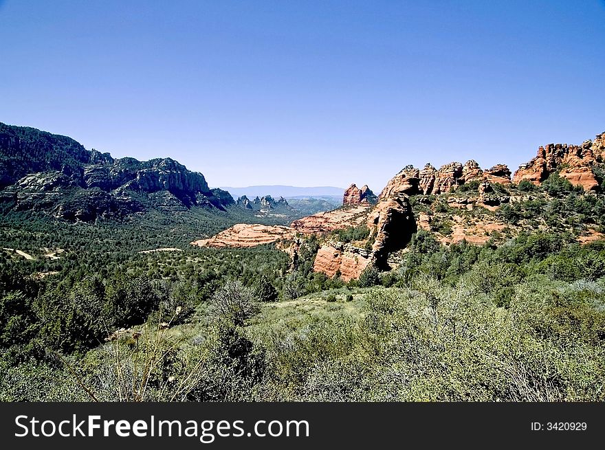 A picture of a valley and rock formations of sedona. A picture of a valley and rock formations of sedona